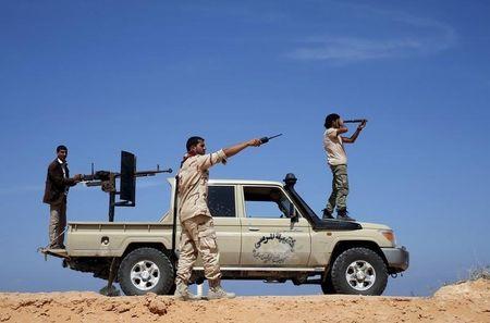 Libya Dawn fighters look at Islamic State (IS) militant positions near Sirte, March 19, 2015. PHOTO BY REUTERS/Goran Tomasevic