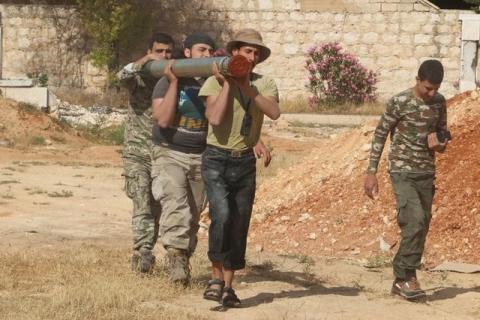 Rebel fighters from the First Regiment, part of the Free Syrian Army, carry a Grad rocket in Aleppo's Al-Haidariya neighbourhood, Syria, May 29, 2016. PHOTO BY REUTERS/Abdalrhman Ismail