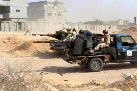 Fighters from forces aligned with Libya's new unity government fire anti-aircraft guns from their vehicles at Islamic State positions in Algharbiyat area, Sirte, June 21, 2016. PHOTO BY REUTERS/Stringer