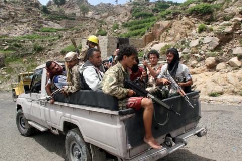 Pro-government fighters ride on the back of a patrol truck in a village taken by pro-government forces from the Iran-allied Houthi militia, in the al-Sarari area of Taiz province, Yemen, July 28, 2016. PHOTO BY REUTERS/Anees Mahyoub