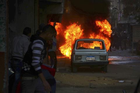 A vehicle is seen on fire during clashes between pro-Mursi protesters and police in eastern Cairo