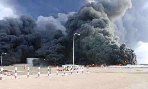 Smoke rises from an oil tank fire in Es Sider port December 26, 2014. A fire at an oil storage tank at Libya's Es Sider port has spread to two more tanks after a rocket hit the country's biggest terminal during clashes between forces allied to competing governments, officials said on Friday. PHOTO BY REUTERS/Stringer