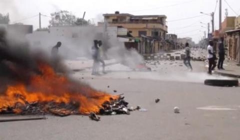 A still image taken from a video shot on October 18, 2017, shows protesters walking past burning tyres in Lome, Togo, October 18, 2017. PHOTO BY REUTERS