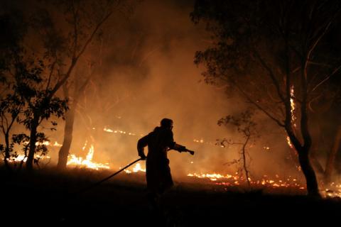 A firefighter from a local brigade works to extinguish flames after a bushfire burnt through the area in Bredbo, New South Wales, Australia, February 2, 2020. PHOTO BY REUTERS/Loren Elliott