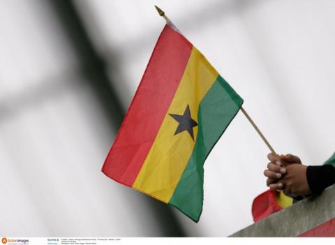 A person holding a Ghana flag. PHOTO BY REUTERS/Action Images/Steven Paston