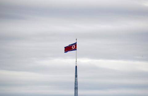 A North Korean flag flutters on top of a 160-metre tower in North Korea's propaganda village of Gijungdong, in this picture taken from the Tae Sung freedom village near the Military Demarcation Line (MDL), inside the demilitarised zone separating the two Koreas, in Paju, South Korea, April 24, 2018. PHOTO BY REUTERS/Kim Hong-Ji