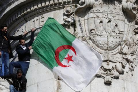 A protestor holds an Algerian flag as people attend a demonstration against President Abdelaziz Bouteflika. PHOTO BY REUTERS/Philippe Wojazer