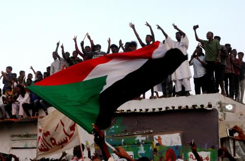 Sudanese people chant slogans and wave their national flag as they celebrate, after Sudan's ruling military council and a coalition of opposition and protest groups reached an agreement to share power during a transition period leading to elections, along the streets of Khartoum, Sudan, July 5, 2019. PHOTO BY REUTERS/Mohamed Nureldin Abdallah