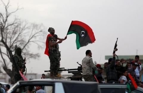 Armed Libyan men wave their national flags in celebrations marking the fifth anniversary of the Libyan revolution, in Benghazi, Libya, February 17, 2016. PHOTO BY REUTERS/Esam Omran Al-Fetori