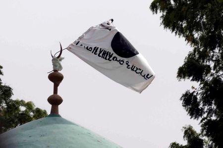 A flag belonging to Boko Haram flies from a atop a mosque in the recently retaken town of Damasak, Nigeria, March 18, 2015. PHOTO BY REUTERS/Emmanuel Braun