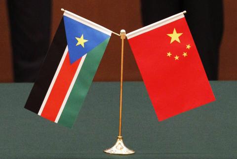 The national flags of South Sudan and China are displayed in front of South Sudan's President Salva Kiir Mayardit and his Chinese counterpart Hu Jintao, during a signing ceremony at the Great Hall of the People in Beijing