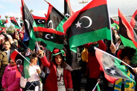 People wave Libyan flags as they gather during celebrations commemorating the 9th anniversary of the revolution at Martyrs' Square in Tripoli Libya, February 17, 2020. PHOTO BY REUTERS/Ismail Zitouny