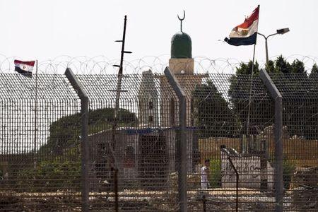 An Egyptian flag flutters near the border fence in North Sinai as seen from across the border in southern Israel, July 2, 2015. PHOTO BY REUTERS/Amir Cohen