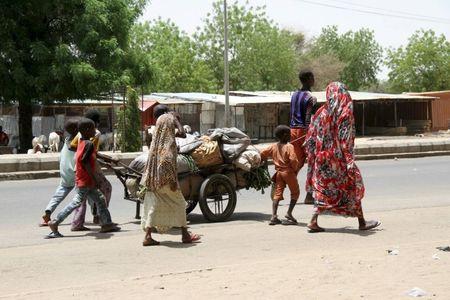 People flee with their belongings in Maiduguri in Borno State, Nigeria, May 14, 2015. PHOTO BY REUTERS/Stringer