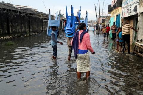 Congolese people wade through floodwaters along a street after the Congo River burst its banks due to heavy rainfall in Kinshasa, Democratic Republic of Congo, January 9, 2020. PHOTO BY REUTERS/Kenny Katombe