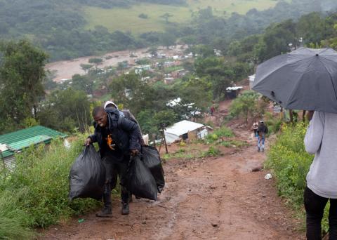 People move their belongings from damaged houses after heavy rains caused flooding in Marianhill, South Africa, April 23, 2019. PHOTO BY REUTERS/Rogan Ward