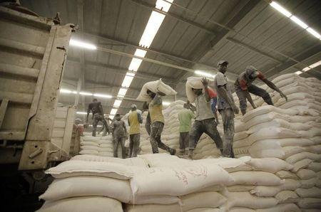 Workers load flour at a storage facility for flour in Tripoli, February 10, 2015. PHOTO BY REUTERS/Ismail Zitouny