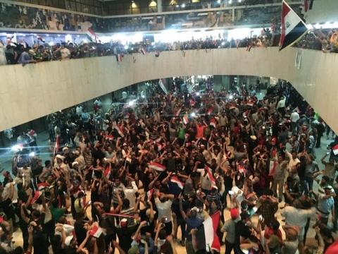 Followers of Iraq's Shi'ite cleric Moqtada al-Sadr are seen in the parliament building as they storm Baghdad's Green Zone after lawmakers failed to convene for a vote on overhauling the government, in Iraq, April 30, 2016. PHOTO BY REUTERS/Ahmed Saad