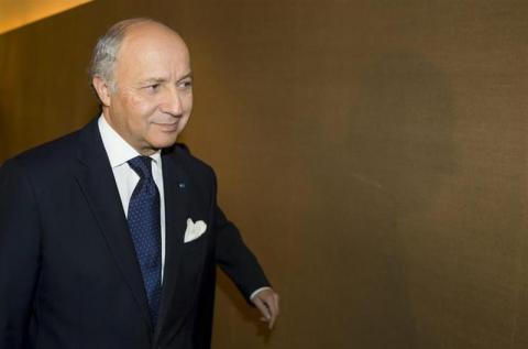 French Foreign Minister Laurent Fabius makes his way to a meeting