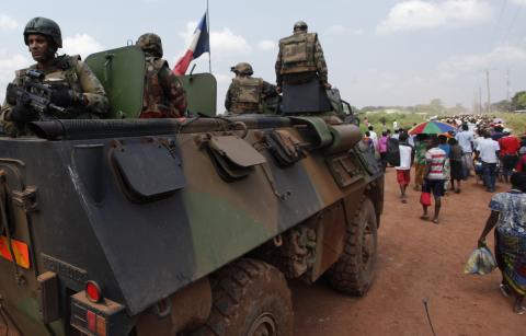 French soldiers take position on their tank while they monitor displaced people leaving after a food distribution process was cancelled in Socati stadium, in Bangui