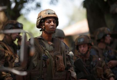 French soldiers stand in front of protesters demonstrating against French troops in Bambari