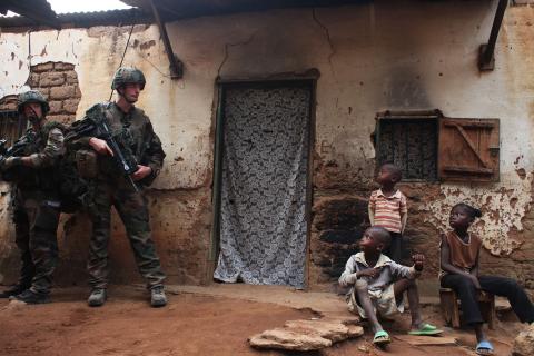 French soldiers conduct a daytime patrol in a neighbourhood in Bangui, where shooting continued overnight in the capital