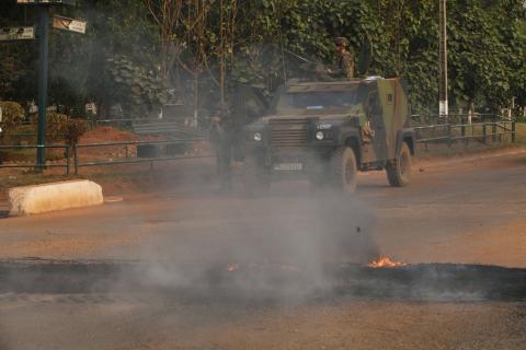 French soldiers of "Operation Sangaris" take position at a military vehicle near burning tyres at Boy-rabe in Bangui February 18, 2014, during a firefight between African peacekeepers and fighters from the Christian "anti-balaka" militia