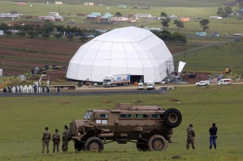 South African military personnel keep guard around the perimeter of Nelson Mandela's property in Qunu, as funeral preparations continue