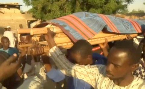 A still image taken from a video shot on November 16, 2017, shows people carrying a dead body, after a suicide bomb attack in the northeast Nigerian city of Maiduguri, Nigeria. PHOTO BY REUTERS