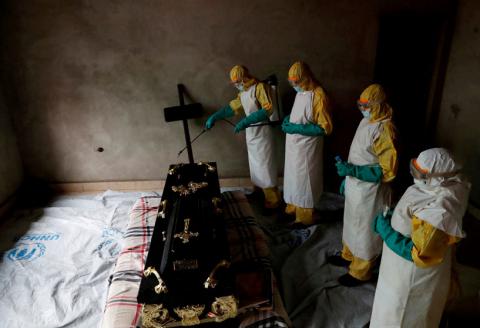 A healthcare worker sprays a room during a funeral of Kavugho Cindi Dorcas who is suspected of dying of Ebola in Beni, North Kivu Province of Democratic Republic of Congo, December 9, 2018. PHOTO BY REUTERS/Goran Tomasevic