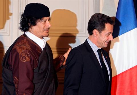 France's President Nicolas Sarkozy (R) and Libyan leader Muammar Gaddafi leave the room after the signature of 10 billion euros of trade contracts between the two countries at the Elysee Palace in Paris, December 10, 2007. PHOTO BY REUTERS/Patrick Hertzog