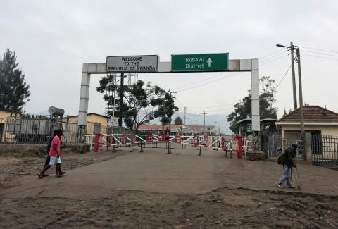 Congolese people walk near the gate barriers at the border crossing point with Rwanda following its closure over Ebola threat in Goma, eastern Democratic Republic of Congo, August 1, 2019. PHOTO BY REUTERS/Djaffer Sabiti