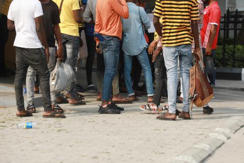 Some of the 47 men charged with public displays of affection with members of the same sex are seen gathered within the premises of the Federal High Court after the court-hearing of their case in Lagos, Nigeria, February 4, 2020. PHOTO BY REUTERS/Temilade Adelaja