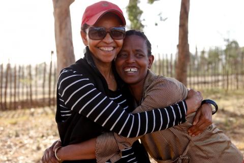 Ethiopian activist Bogaletch Gebre (L) hugs Almaz Someno, a staff member of the charity Kembatti Mentti Gezzimma. PHOTO BY REUTERS/Martin Dixon