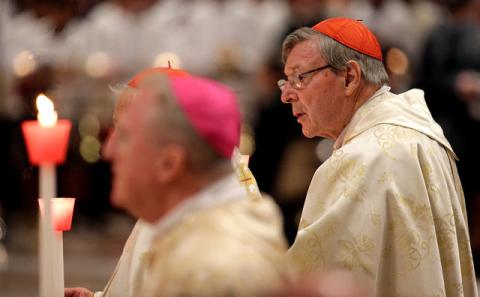 Australian Cardinal George Pell holds a candle as Pope Francis leads the Easter vigil mass in Saint Peter's Basilica at the Vatican, April 15, 2017. PHOTO BY REUTERS/Max Rossi