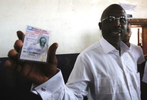 George Weah, former soccer player and presidential candidate of Congress for Democratic Change (CDC) shows his voter's card at a polling station in Monrovia, Liberia, October 10, 2017. PHOTO BY REUTERS/Thierry Gouegnon