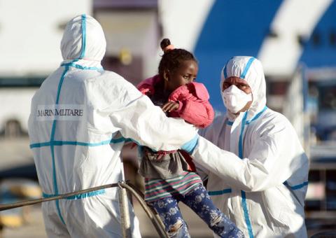 Members of the Italian Navy hold a child after disembarking from the Italian Navy ship Borsini in the Sicilian harbour of Palermo, southern Italy, July 20, 2016. PHOTO BY REUTERS/ Guglielmo Mangiapane