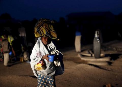 A girl rescued from Boko Haram in Sambisa forest by Nigeria Military carries her food as she arrives at the Internally displaced people's camp in Yola, Adamawa State, Nigeria, May 2, 2015. PHOTO BY REUTERS/Afolabi Sotunde