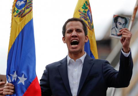 Juan Guaido, President of Venezuela's National Assembly, holds a copy of Venezuelan constitution during a rally against Venezuelan President Nicolas Maduro's government and to commemorate the 61st anniversary of the end of the dictatorship of Marcos Perez Jimenez in Caracas, Venezuela, January 23, 2019. PHOTO BY REUTERS/Carlos Garcia Rawlins