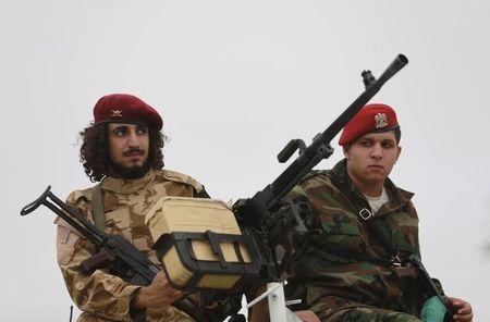 Members of the military guard a protest against candidates for a national unity government proposed by U.N. envoy for Libya Bernardino Leon, in Benghazi, Libya, October 16, 2015. PHOTO BY REUTERS/Esam Omran Al-Fetori