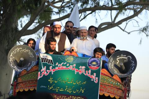 Hafiz Saeed, head of the Jamaat-ud-Dawa organisation and founder of Lashkar-e-Taiba, stand on a truck with others during a rally to mark the 16th anniversary of Pakistan's first successful nuclear test in 1998, in Islamabad