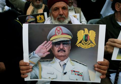 A Libyan man carries a picture of Khalifa Haftar during a demonstration to support Libyan National Army offensive against Tripoli, in Benghazi, Libya, April 12, 2019. PHOTO BY REUTERS/Esam Omran Al-Fetori