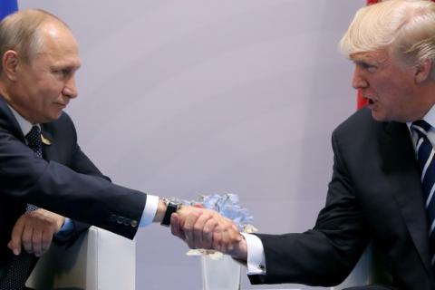 U.S. President Donald Trump shakes hands with Russian President Vladimir Putin during the their bilateral meeting at the G20 summit in Hamburg, Germany, July 7, 2017. PHOTO BY REUTERS/Carlos Barria