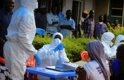 Congolese and the World Health Organization officials wear protective suits as they prepare equipment before the launch of vaccination campaign against the deadly Ebola virus near Mangina village, near the town of Beni in North Kivu province of the Democratic Republic of Congo, August 8, 2018. PHOTO BY REUTERS/Samuel Mambo