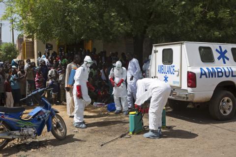 Health workers put on protective gear outside a mosque before disinfecting it, in Bamako, November 14, 2014. PHOTO BY REUTERS/Joe Penney