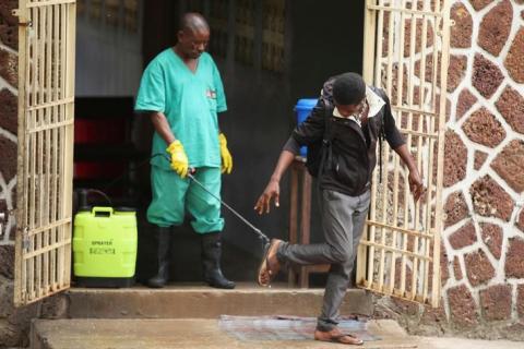 A health worker sprays a visitor with chlorine after leaving the isolation facility, prepared to receive suspected Ebola cases, at the Mbandaka General Hospital, in Mbandaka, Democratic Republic of Congo, May 20, 2018. PHOTO BY REUTERS/Kenny Katombe