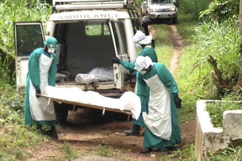 Health workers carry the body of an Ebola virus victim in Kenema, Sierra Leone