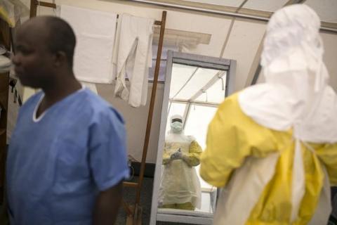 Health workers put on protective gear before entering a quarantine zone at a Red Cross facility in the town of Koidu, Kono district in Eastern Sierra Leone, December 19, 2014. PHOTO BY REUTERS/Baz Ratner