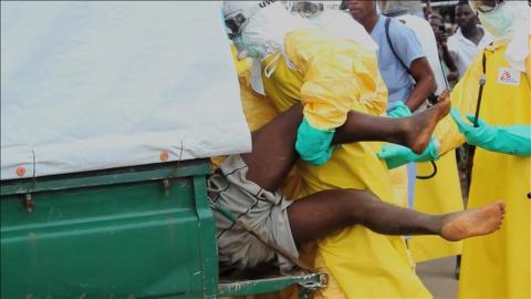 Health workers push an Ebola patient who escaped from quarantine from Monrovia's Elwa hospital, into an ambulance in the centre of Paynesville in this still image taken from a September 1, 2014 video