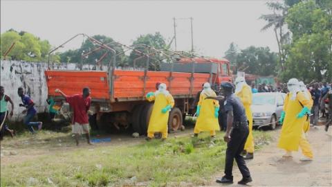 Health workers surround an Ebola patient who escaped from quarantine from Monrovia's Elwa hospital, in the centre of Paynesville in this still image taken from a September 1, 2014 video